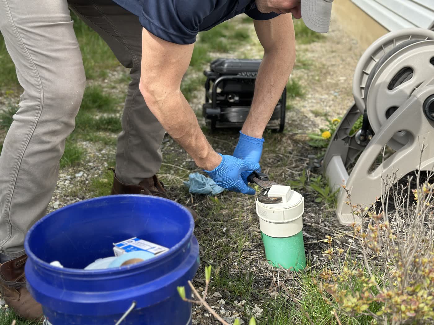 Closing the cleanout cap at the end of a residential sewer scope inspection.