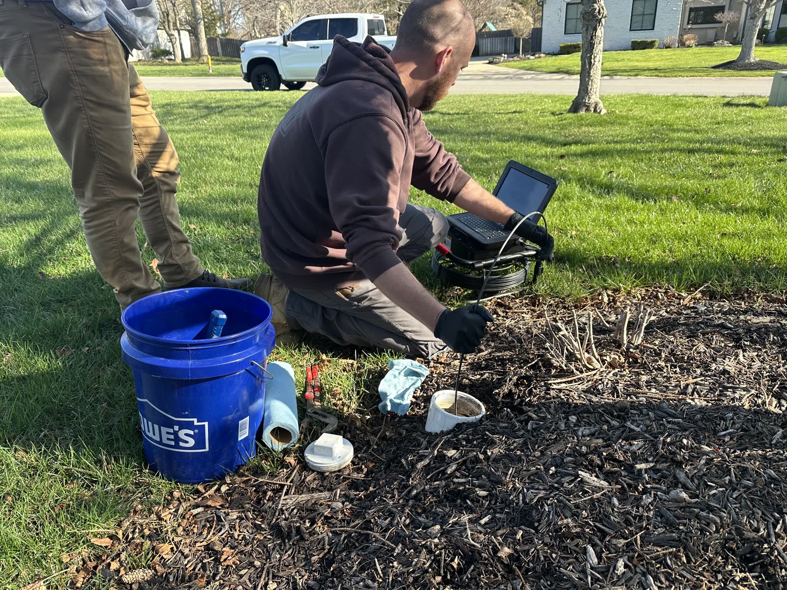 Sewer Scope inspector running the camera from a yard cleanout in Indianapolis