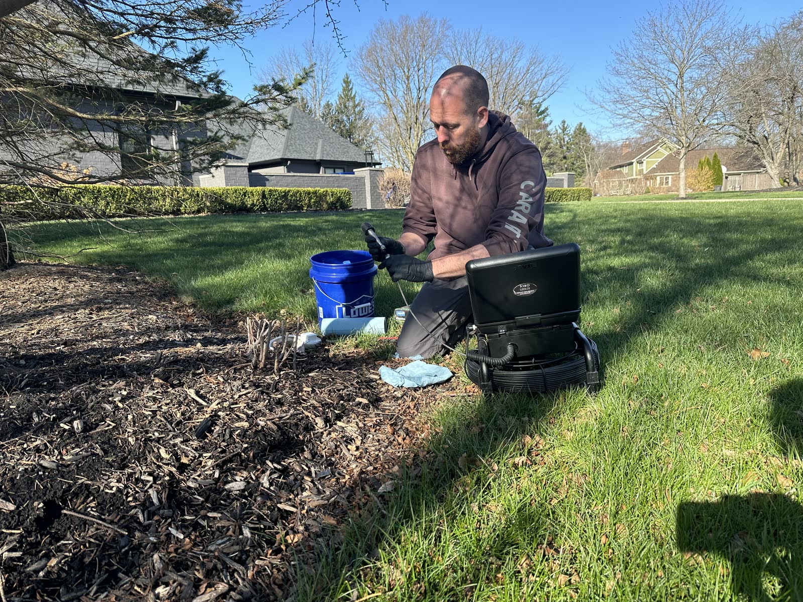 Inspector reviewing the live sewer camera monitor during a residential scope